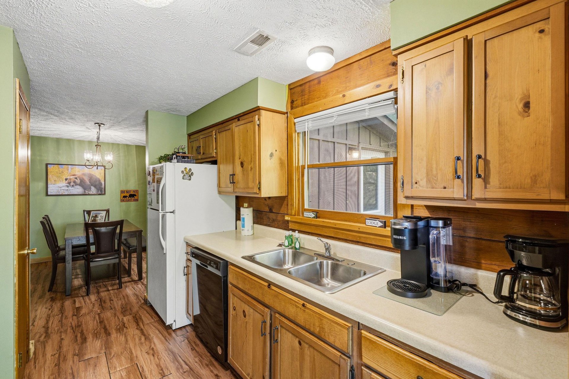 Your fully equipped kitchen features warm wood cabinets and modern appliances, perfect for preparing meals during your stay.