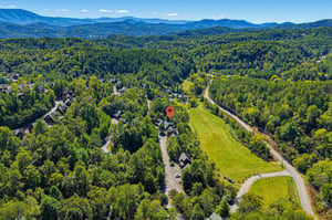Nestled in a lush mountain valley surrounded by rolling forested peaks, this peaceful retreat offers a serene escape into natures beauty.