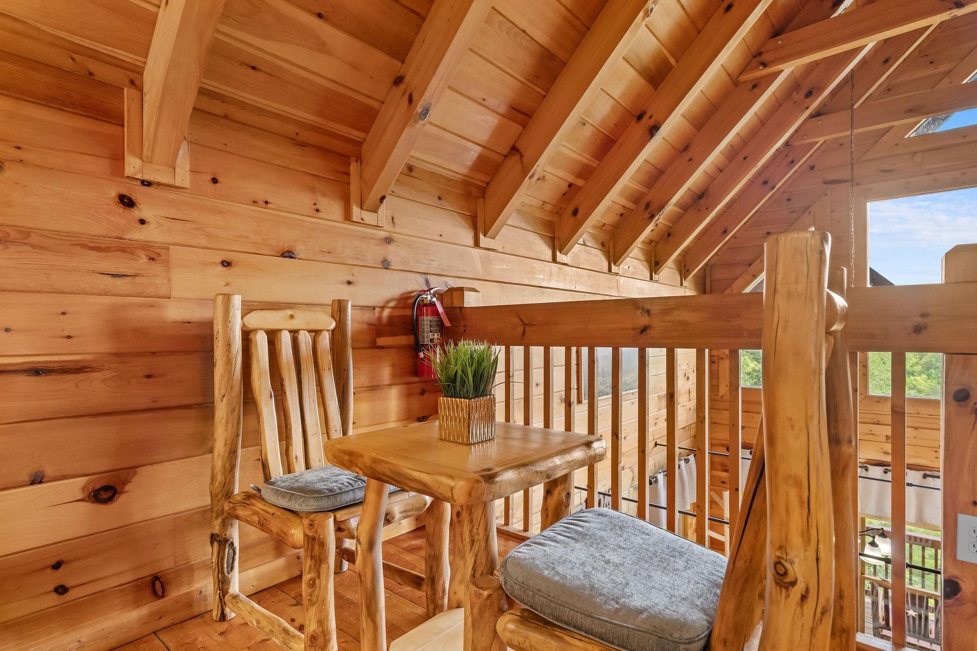 Loft with table and chairs outside of bedroom