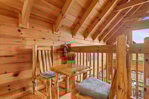 Loft with table and chairs outside of bedroom