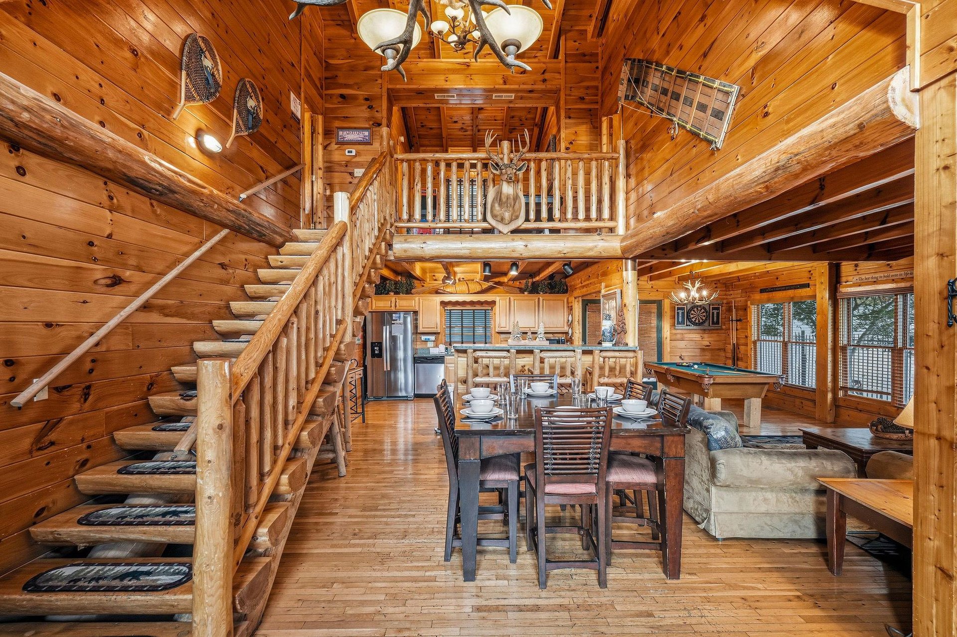 Relax in this spacious, rustic cabin with vaulted ceilings, a loft overlooking the dining area, and cozy seating perfect for gathering with loved ones.