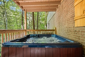 Sink into your private hot tub surrounded by lush forest views. The covered deck keeps you sheltered while natures canopy creates a peaceful escape just steps from your door.