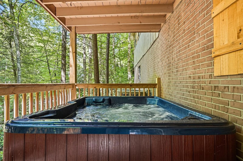 Sink into your private hot tub surrounded by lush forest views. The covered deck keeps you sheltered while natures canopy creates a peaceful escape just steps from your door.