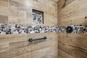 Refresh and rejuvenate in your beautifully tiled walkin shower, featuring natural stone accents and modern fixtures designed for your comfort.
