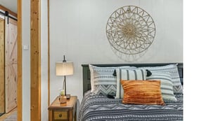 Sink into your cozy bedroom retreat, where rustic wood beams meet modern comfort and thoughtful touches create the perfect restful sanctuary.