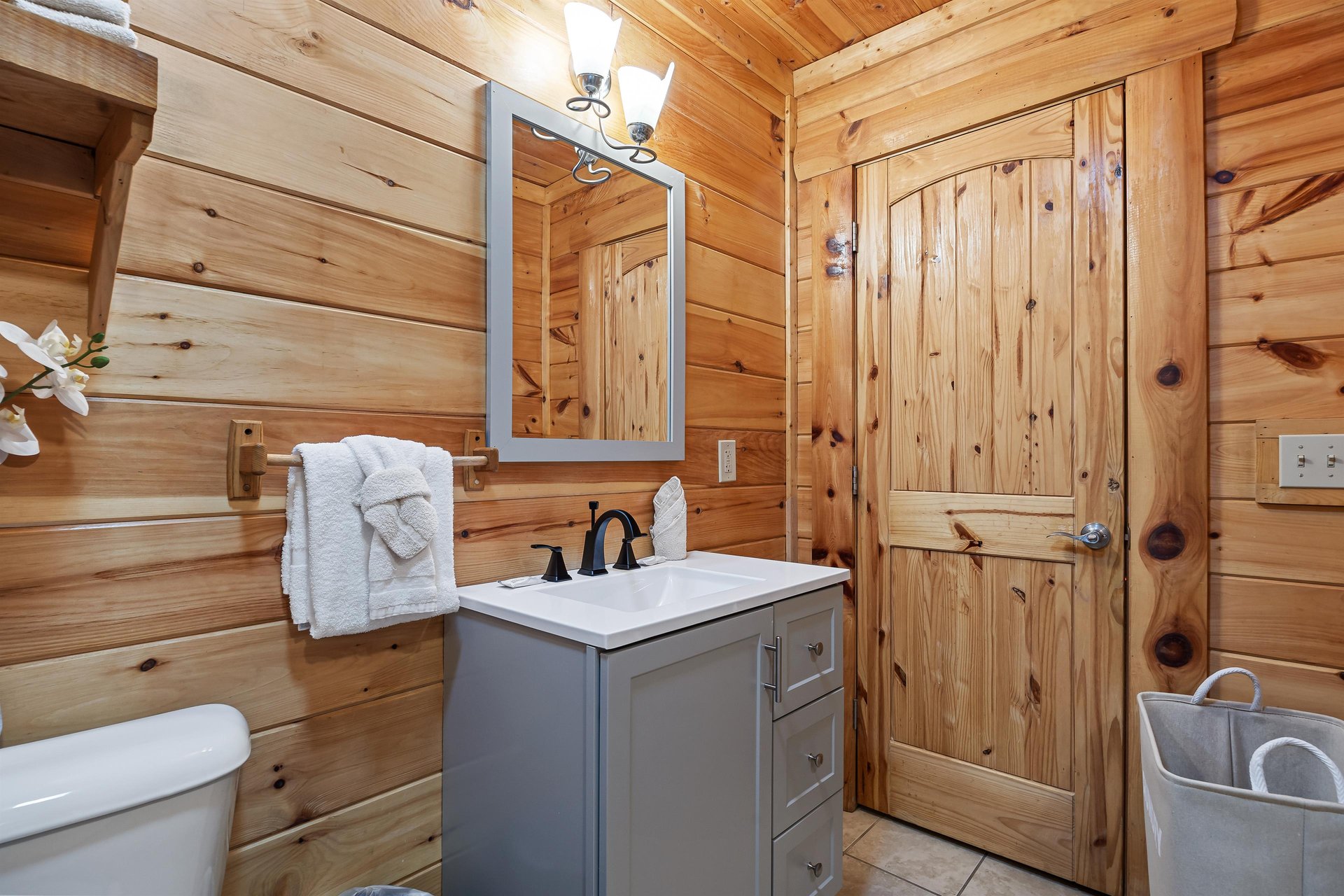 Single vanity sink beside toilet
