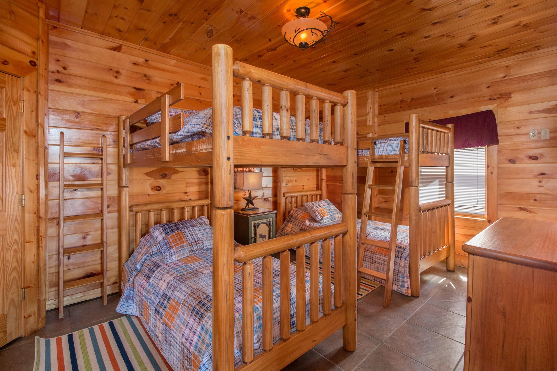 Bedroom with four bunk beds at EllaVation, a 3 bedroom cabin rental located in Gatlinburg