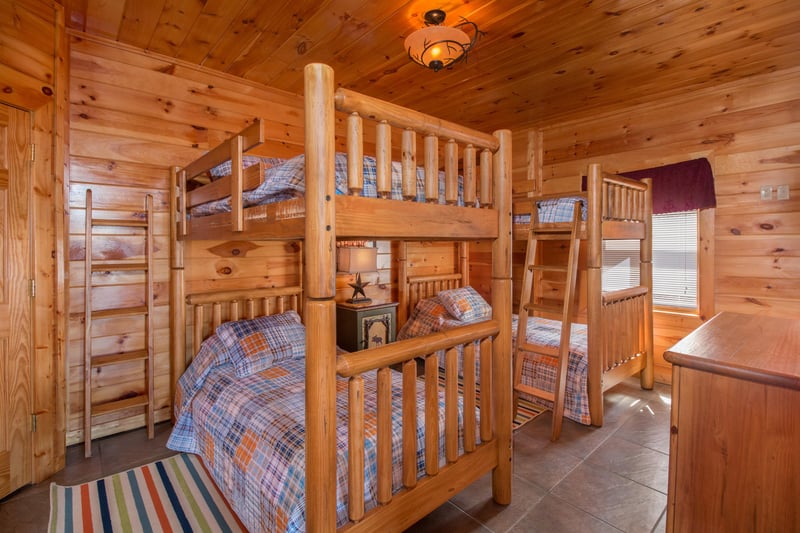Bedroom with four bunk beds at EllaVation, a 3 bedroom cabin rental located in Gatlinburg