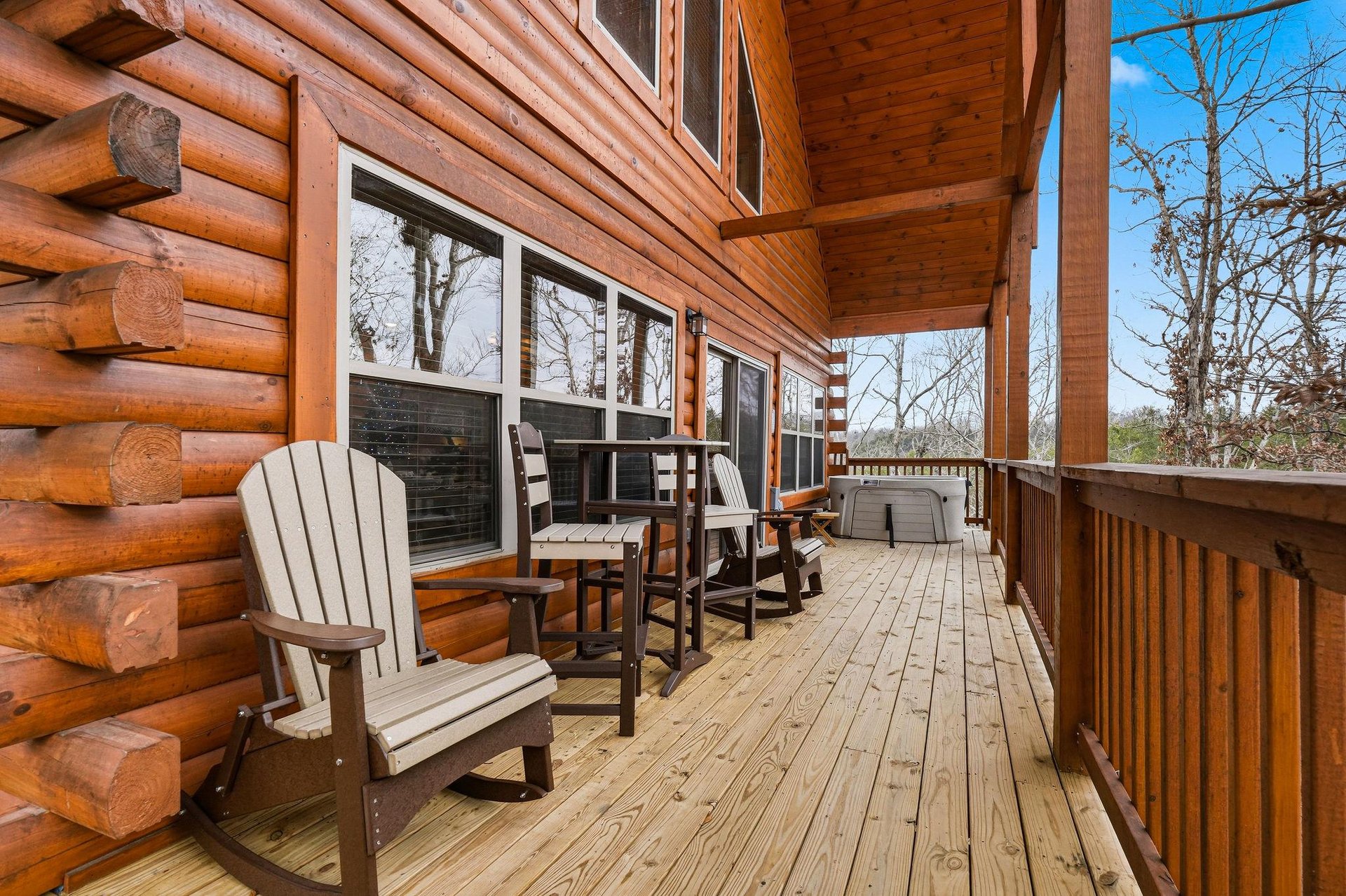 Step onto your private wooden deck where cozy Adirondack chairs await your morning coffee and peaceful moments surrounded by nature.