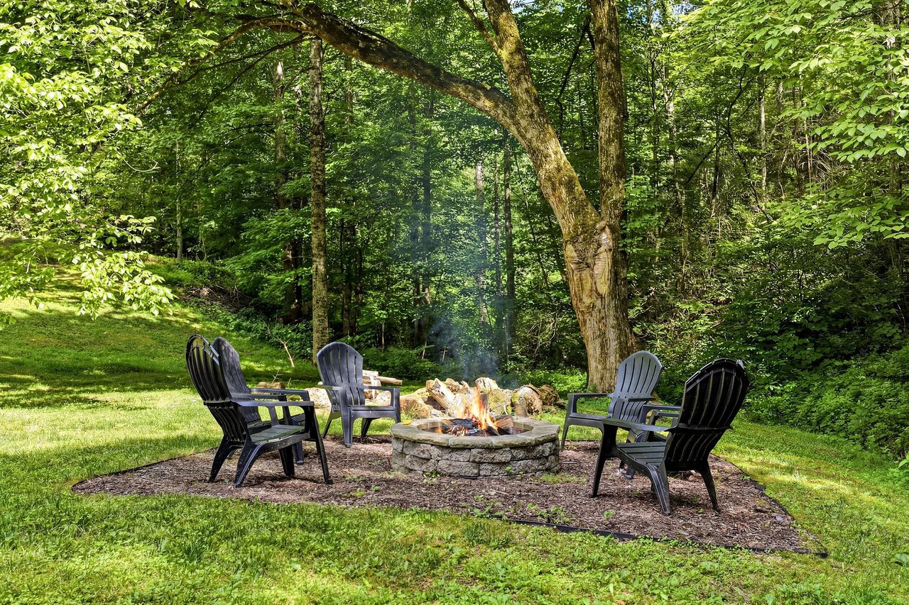 Gather around the stone fire pit surrounded by forest views, perfect for evening smores and storytelling under the trees.