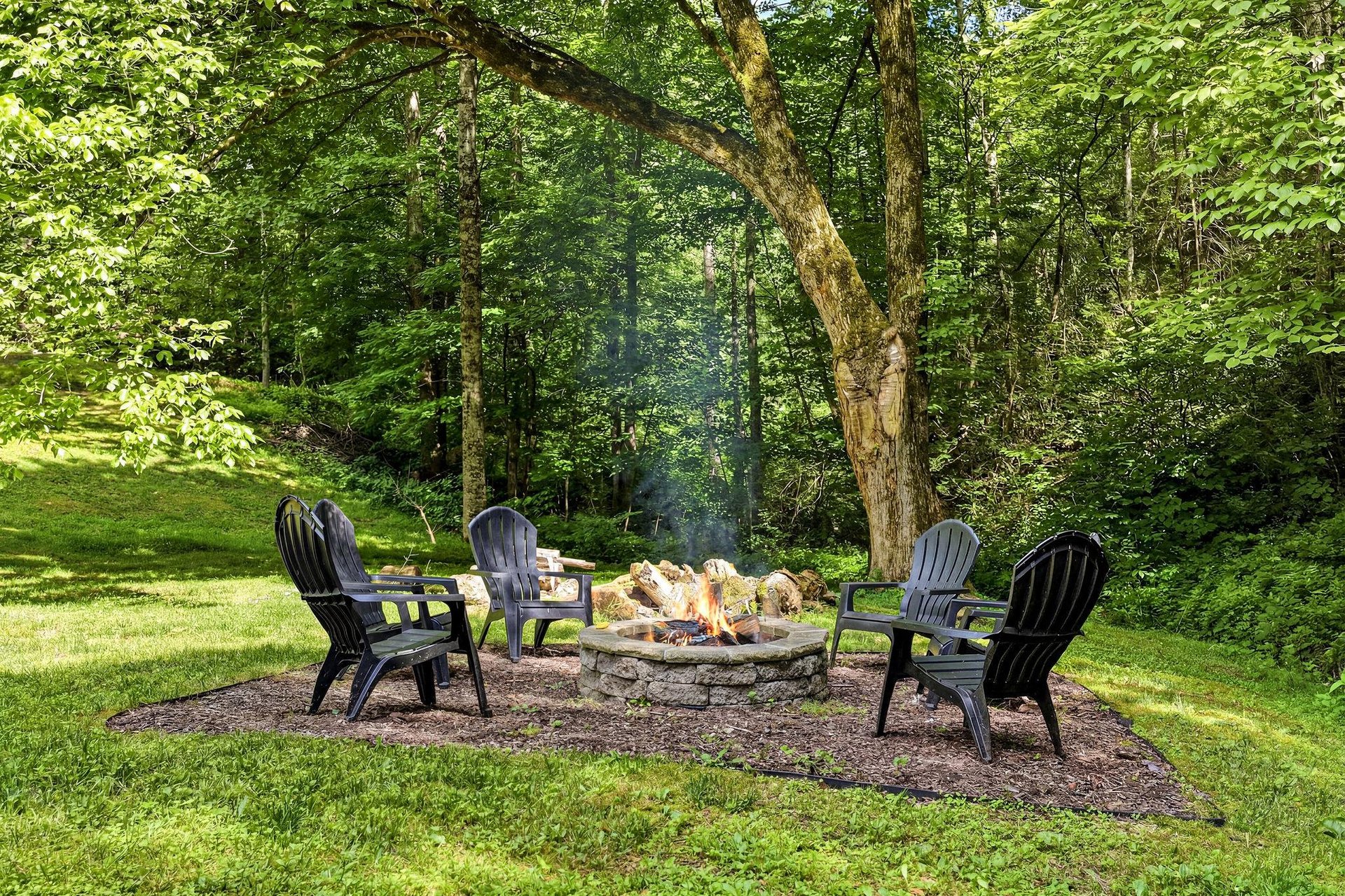 Gather around the stone fire pit surrounded by forest views, perfect for evening smores and storytelling under the trees.