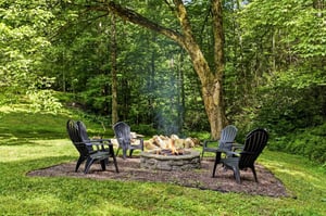 Gather around the stone fire pit surrounded by forest views, perfect for evening smores and storytelling under the trees.