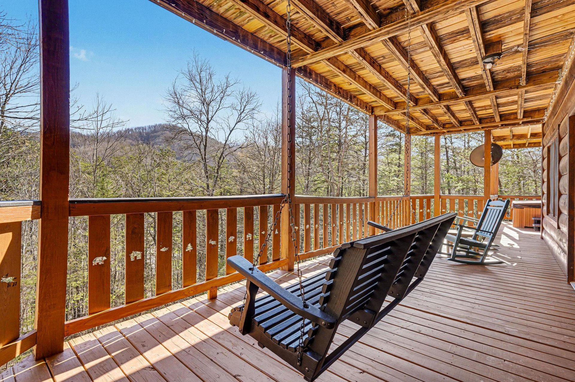 Settle into your peaceful deck chairs and soak in breathtaking mountain vistas through towering trees—your perfect retreat awaits.