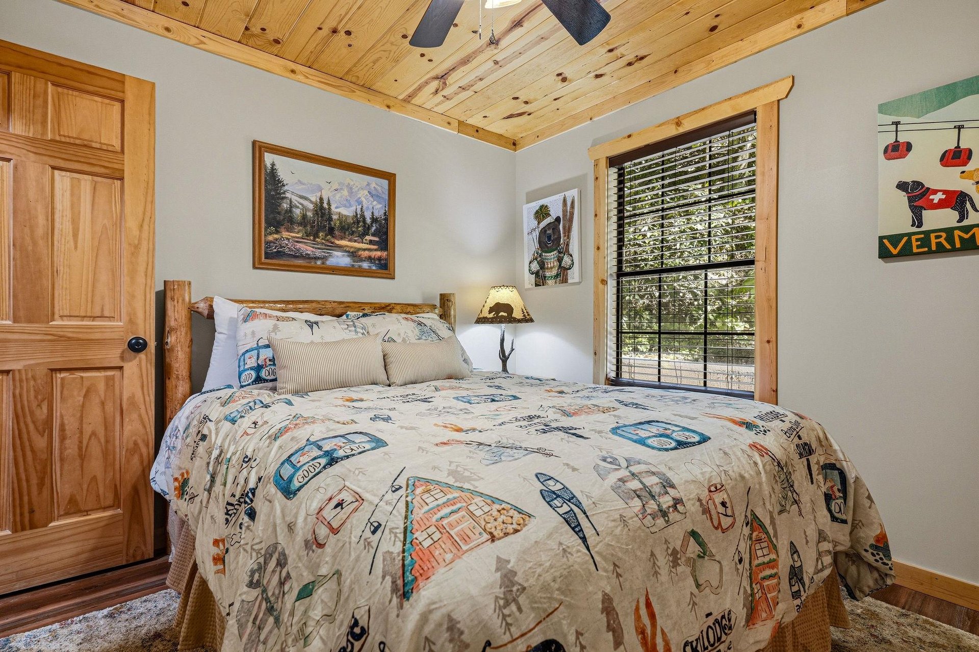 Settle into your cozy retreat with rustic wood details, a plush bed, and natural light streaming through the window.