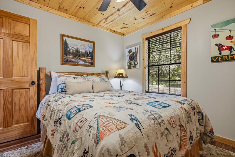 Settle into your cozy retreat with rustic wood details, a plush bed, and natural light streaming through the window.
