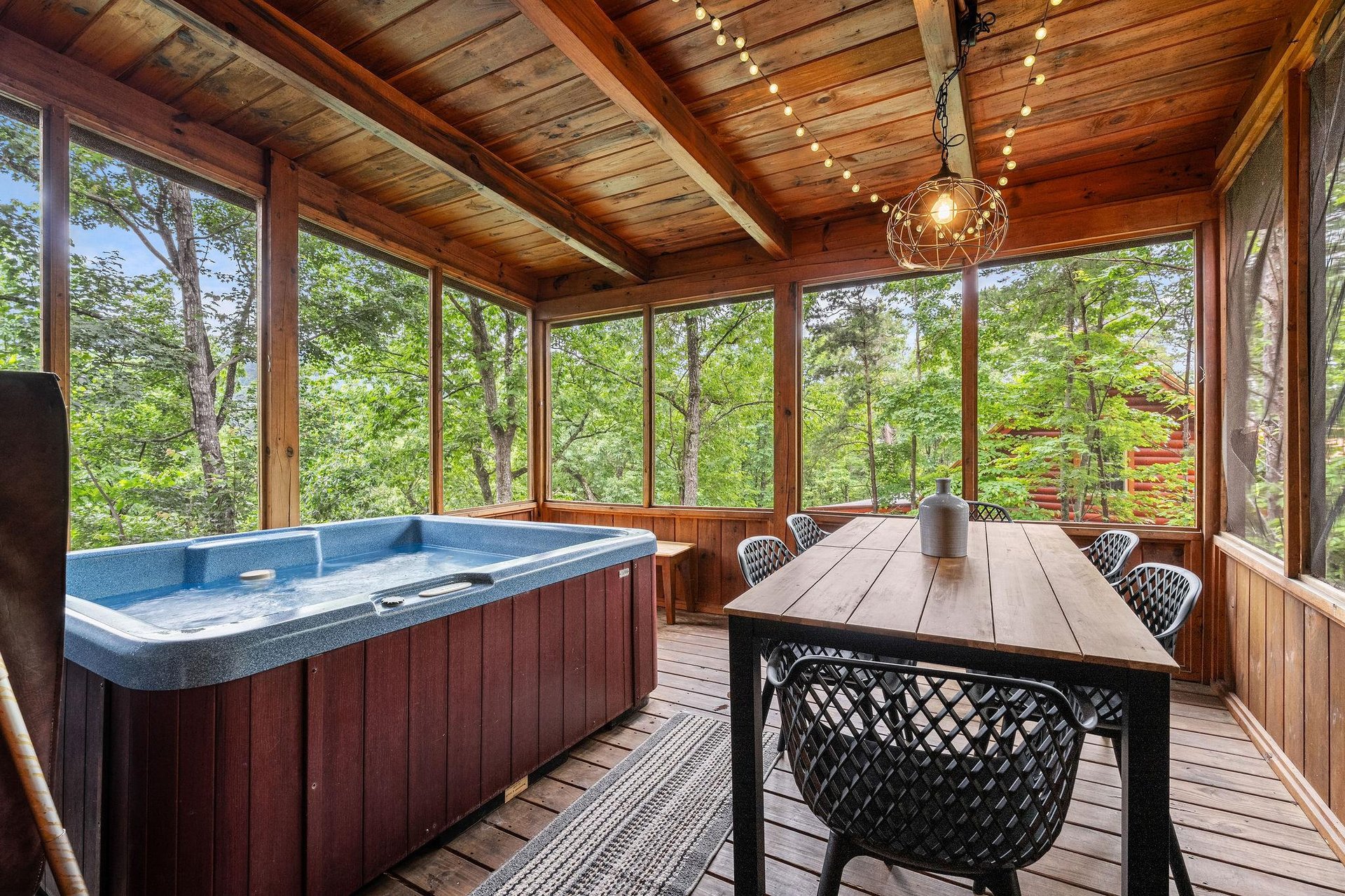 hot tub access with outdoor dining on entry level back porch