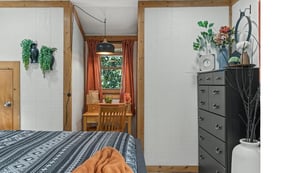 Cozy bedroom with natural wood accents and warm textiles creates your peaceful retreat.