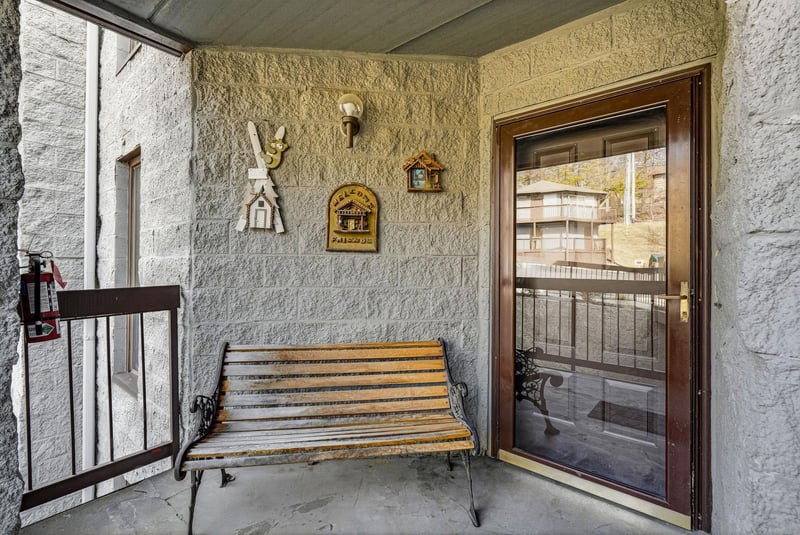 Step onto your private balcony where rustic charm meets mountain hospitality—settle into the wooden bench and soak in authentic alpine atmosphere.