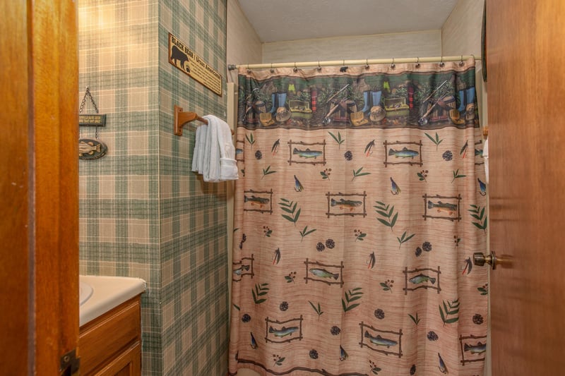 Bathroom with a tub and shower at Black Bear Ridge, a 3bedroom cabin rental located in Pigeon Forge