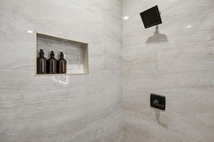Step into your spalike marble shower with premium amenities and rainfall showerhead for the ultimate relaxation.