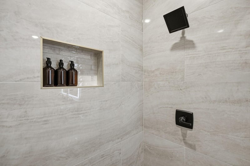 Step into your spalike marble shower with premium amenities and rainfall showerhead for the ultimate relaxation.