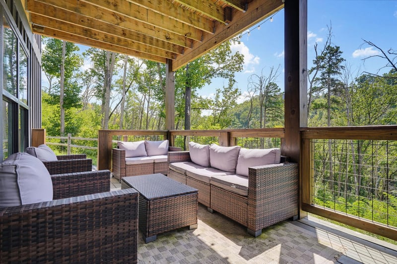 Settle into your private covered terrace and breathe in the fresh forest air. Comfortable seating invites you to unwind surrounded by towering trees and peaceful greenery—your perfect spot to relax wi