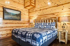 Cozy log cabin bedroom where youll drift off surrounded by rustic charm and woodlandthemed bedding.