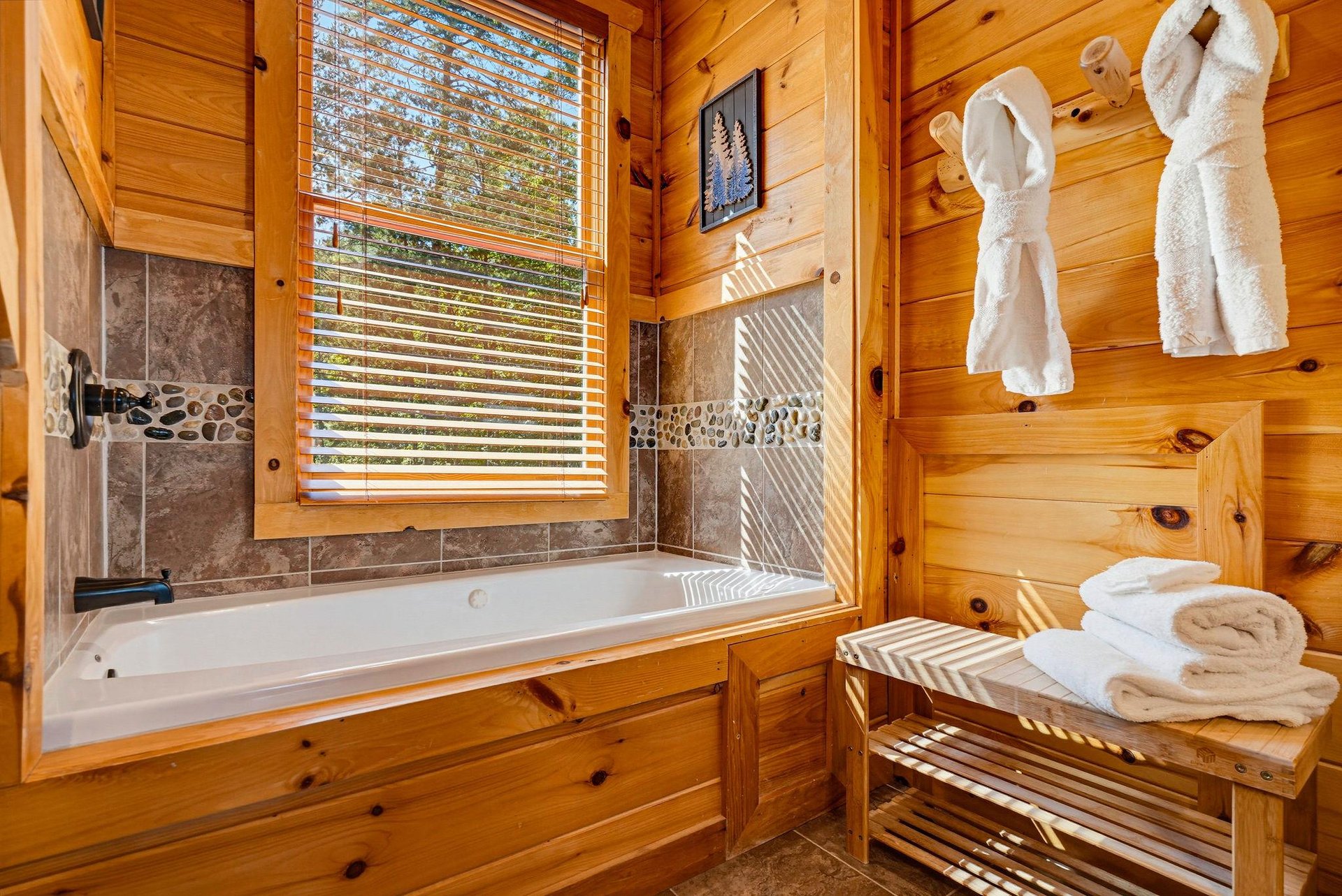 Sink into the deep soaking tub after a day exploring the woods. Warm pine walls, natural light, and plush towels and robes make this your personal spa retreat.