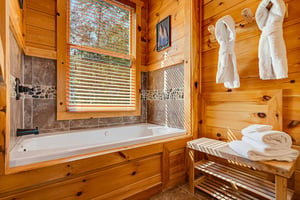 Sink into the deep soaking tub after a day exploring the woods. Warm pine walls, natural light, and plush towels and robes make this your personal spa retreat.