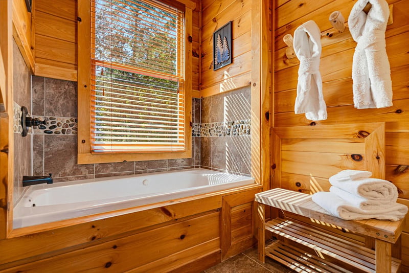 Sink into the deep soaking tub after a day exploring the woods. Warm pine walls, natural light, and plush towels and robes make this your personal spa retreat.
