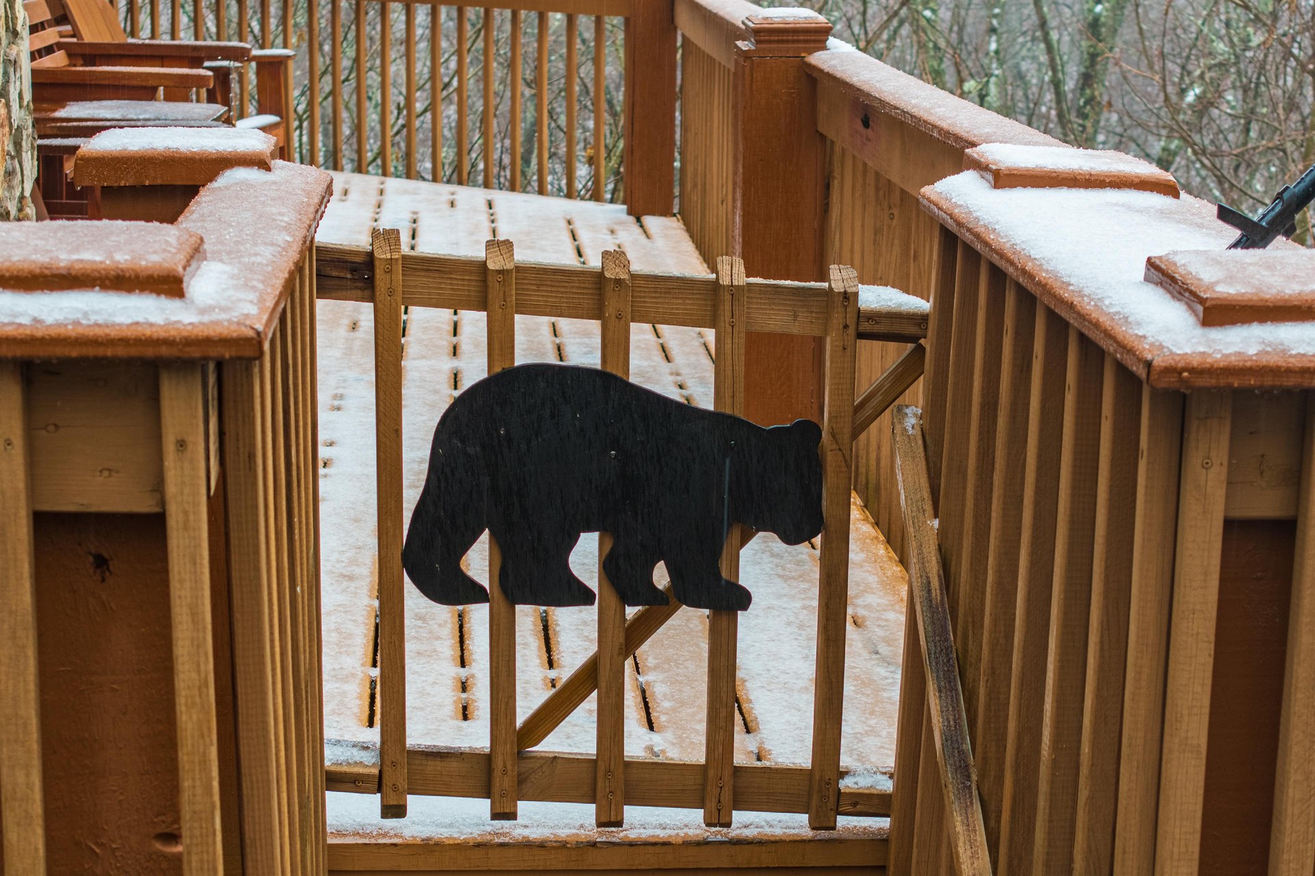 Snowy open deck at Lazy Bear Retreat, a 4 bedroom cabin rental located in Pigeon Forge