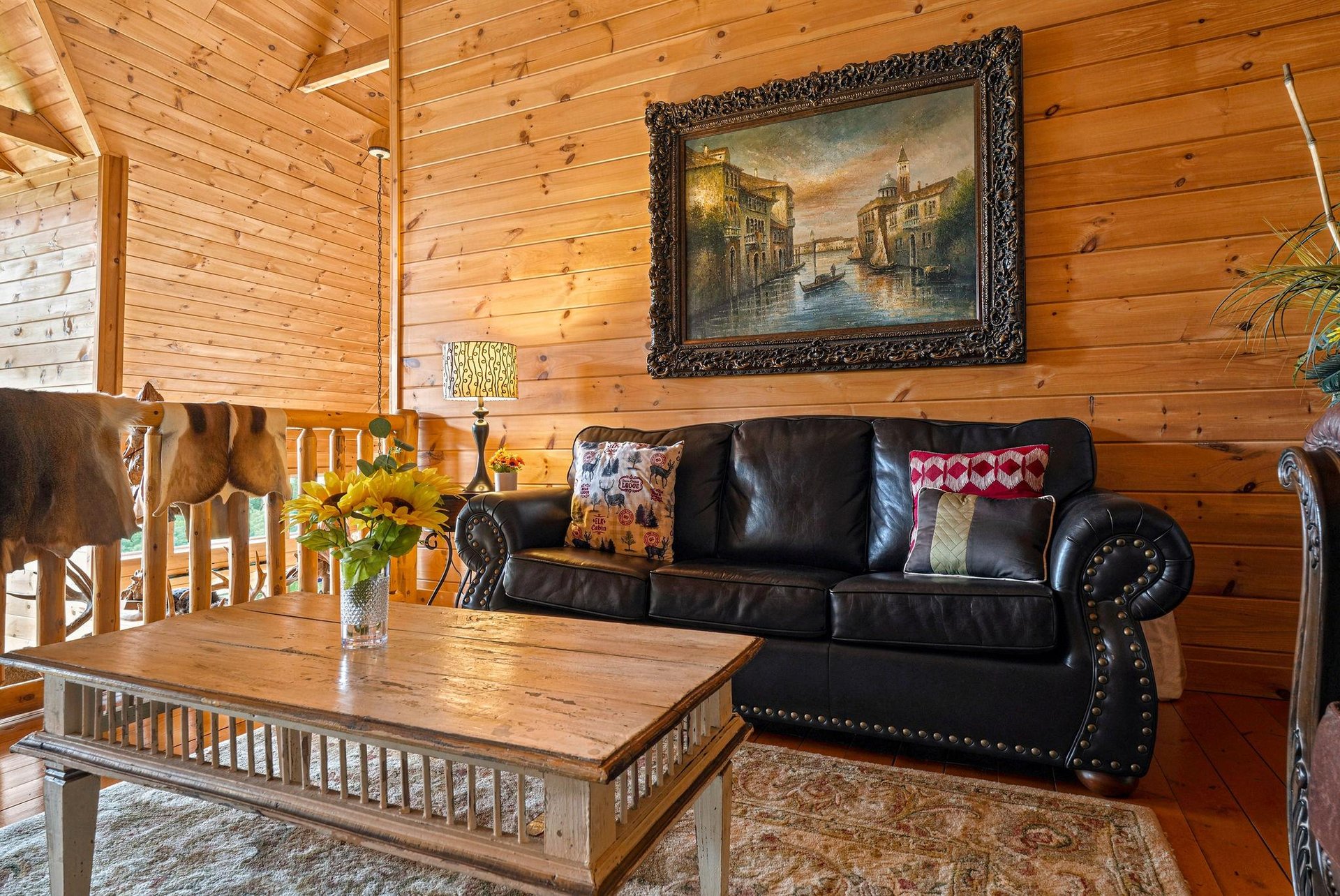 Sink into the rich leather sofa and feel the warmth of natural wood surrounding you, creating your perfect retreat for relaxation.