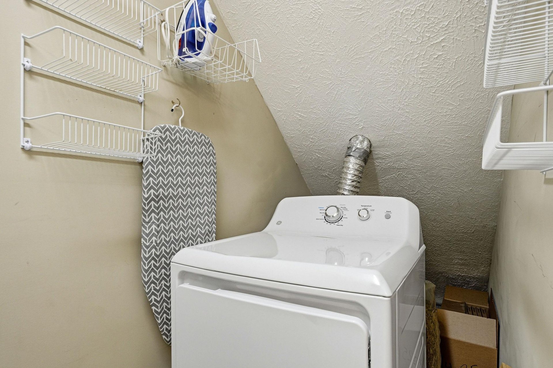 Your dedicated laundry space keeps your clothes fresh during your stay, with convenient storage shelves for all your needs.
