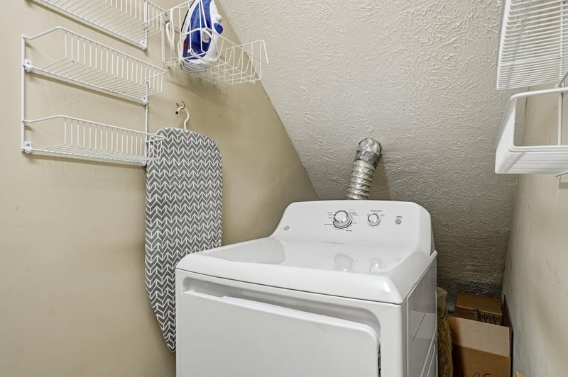 Your dedicated laundry space keeps your clothes fresh during your stay, with convenient storage shelves for all your needs.