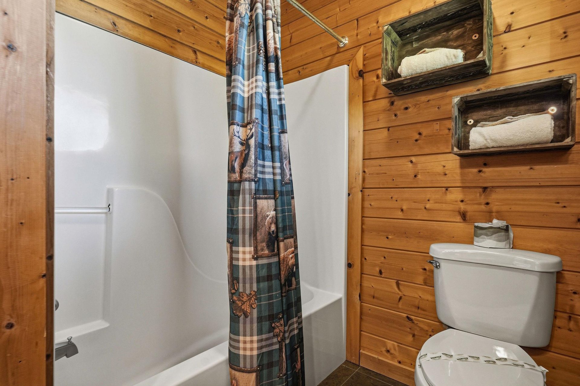 Step into your cozy cabin bathroom, where rustic wood walls and clever storage bring warmth and convenience together, making you feel right at home.