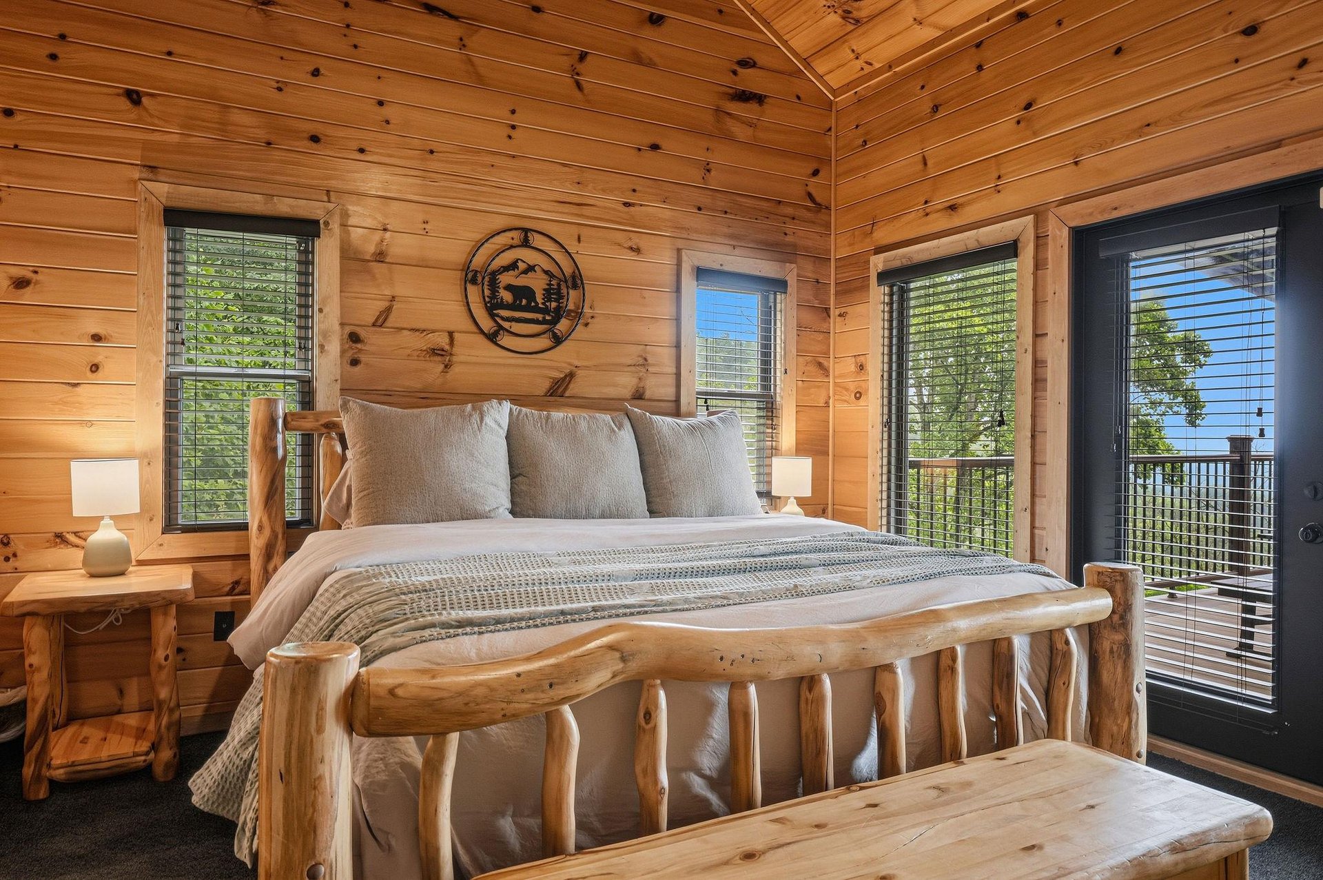 Sink into luxurious comfort in your private bedroom with stunning lake views through French doors and a handcrafted log bed that brings the beauty of the outdoors inside.