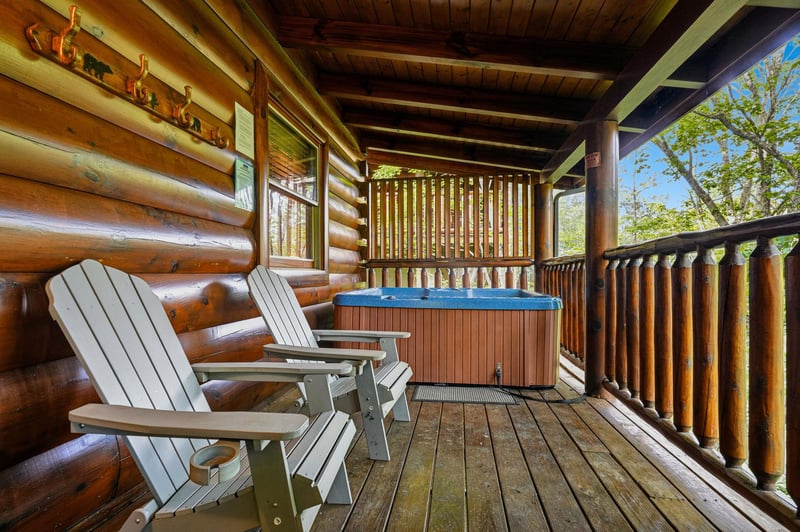 Unwind on your private deck with rustic Adirondack chairs and bubbling hot tub, surrounded by towering trees and mountain views.