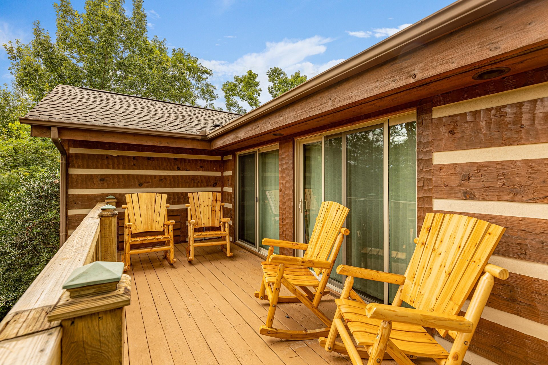 Deck with four rocking chairs at Cubs Crib, a 3 bedroom cabin rental located in Gatlinburg