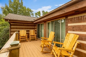 Deck with four rocking chairs at Cubs Crib, a 3 bedroom cabin rental located in Gatlinburg