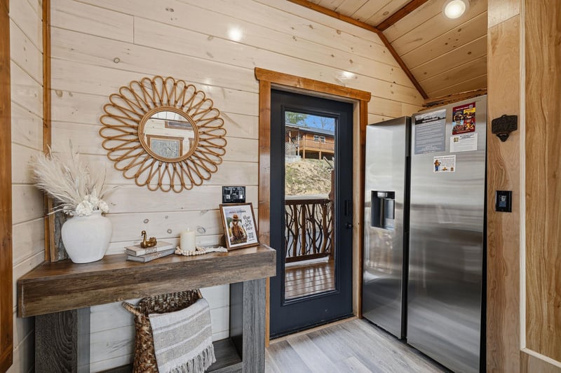 Step into your stylish mountain retreat where rustic wood meets modern comfort, complete with a fullsized refrigerator for all your culinary adventures.