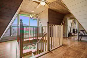 Warm wood floors and soaring ceilings create your perfect mountain retreat, with stunning lake views from every angle.