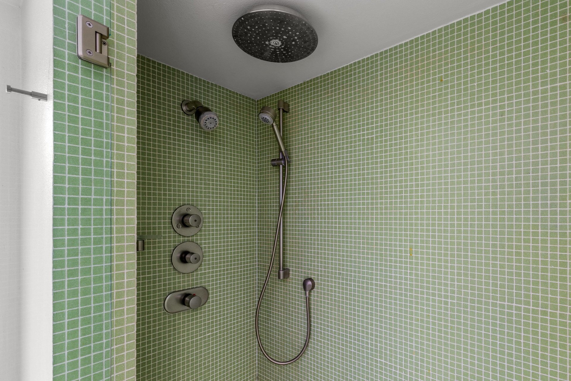 Ensuite bathroom with incredible tile, standalone shower, and door to the outside.