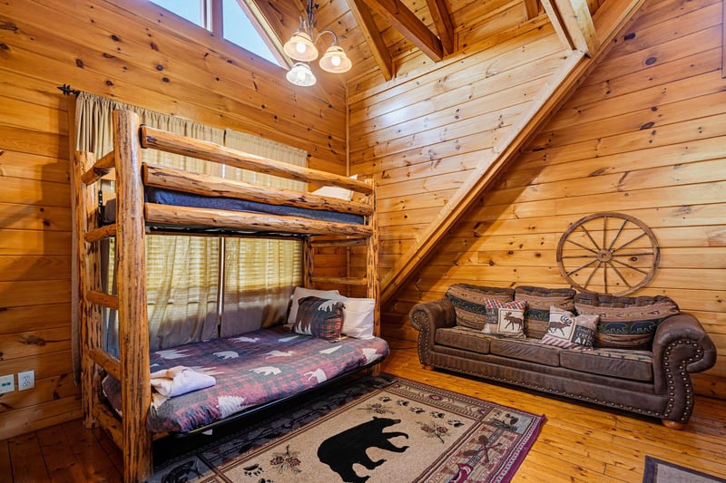 Warm pine walls and vaulted ceilings set a cozy, cabinstyle tone. Rustic bunk beds and plush seating invite you to relax after your mountain adventures.