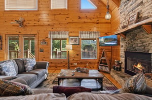 Sink into plush seating by your stone fireplace and feel the warmth of rustic wood walls surrounding you in this inviting mountain retreat.