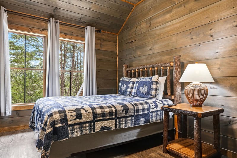 Drift into restful sleep surrounded by warm wood walls and the beauty of nature just beyond your windows. Your charming bedroom features a handcrafted log bed and cozy bedding for peaceful nights.