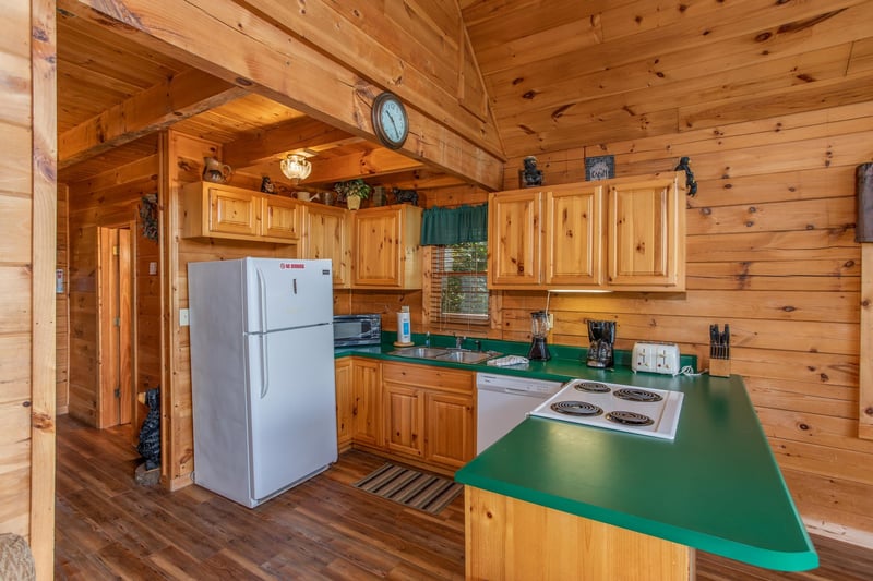 kitchen with white appliances at angels majestic view a 3 bedroom cabin rental located in pigeon forge