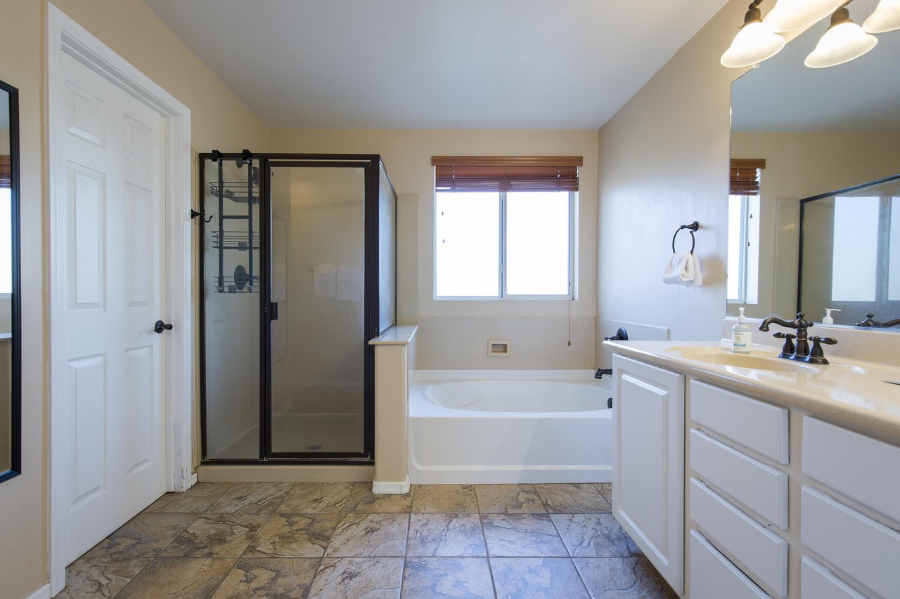 Dual vanity sinks, stand alone tub, and stand alone shower.