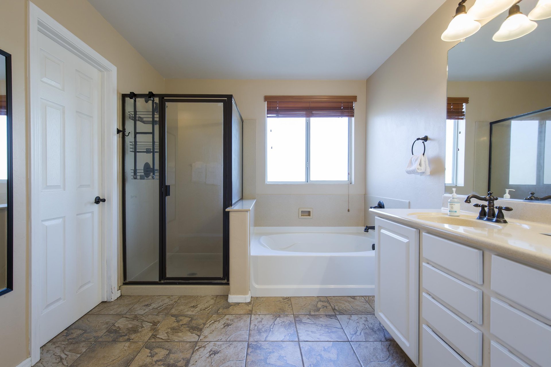 Dual vanity sinks, stand alone tub, and stand alone shower.