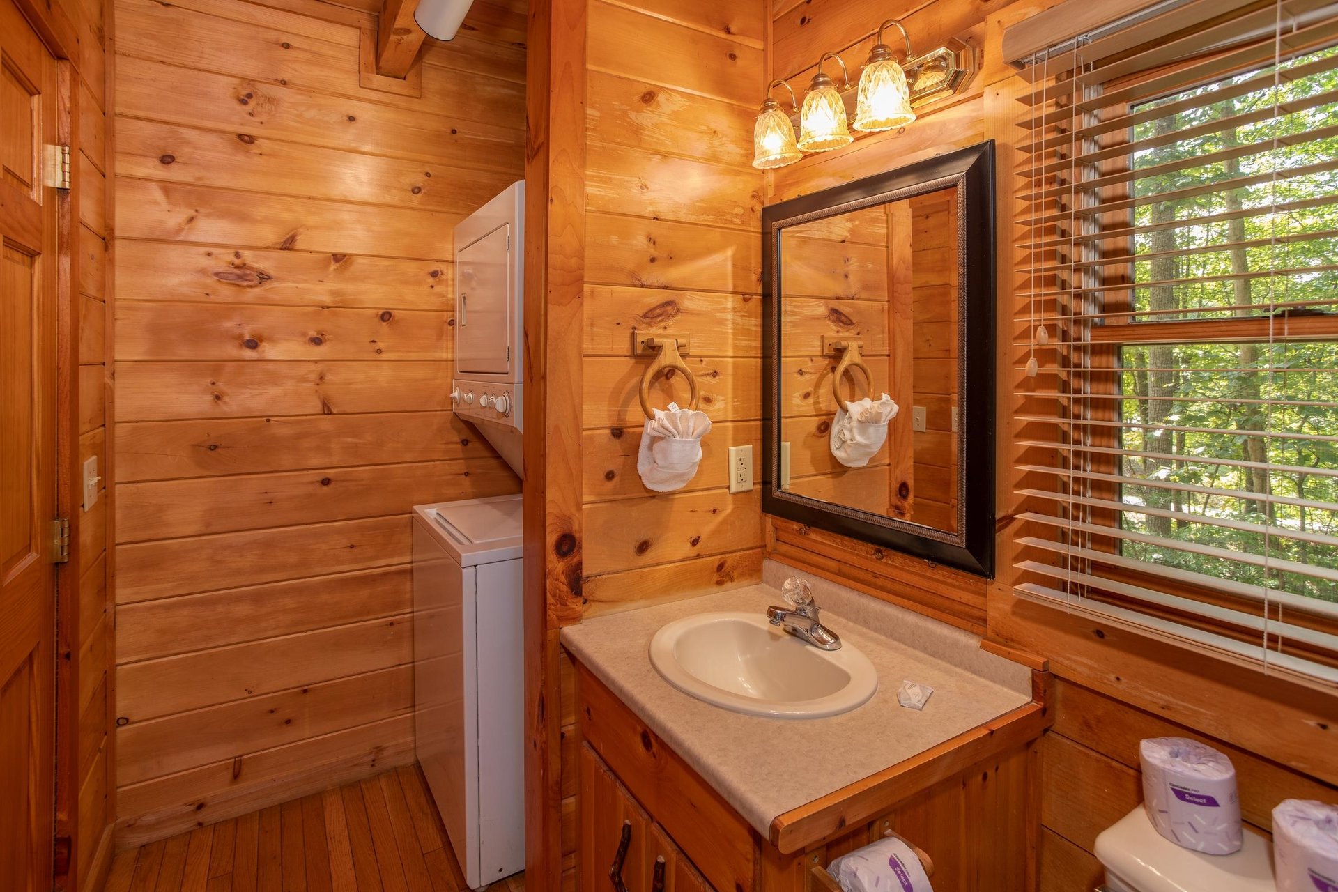 Bathroom with a stacked washer and dryer at Dreams Do Come True, a 1bedroom cabin rental located in Pigeon Forge
