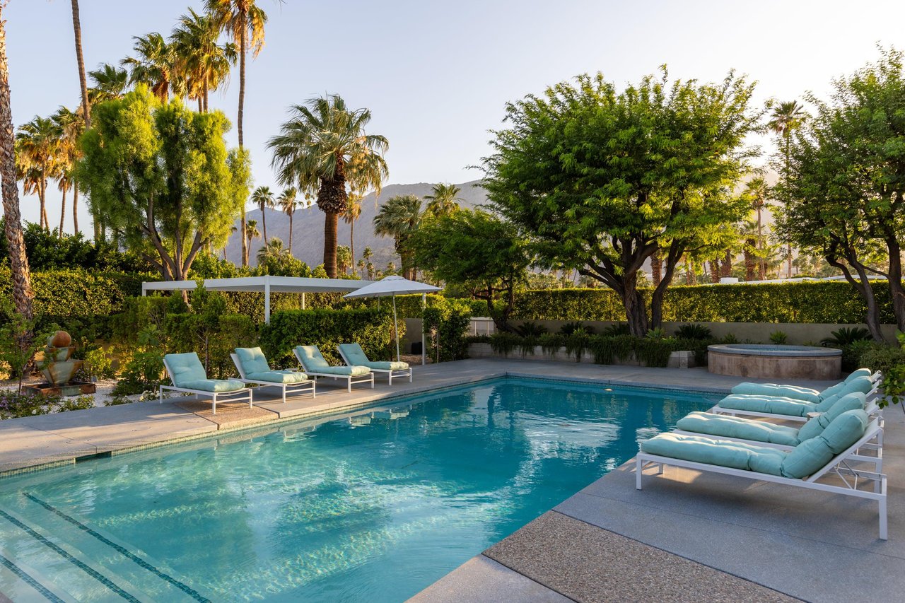 Private poolspa with sun loungers and umbrellas.